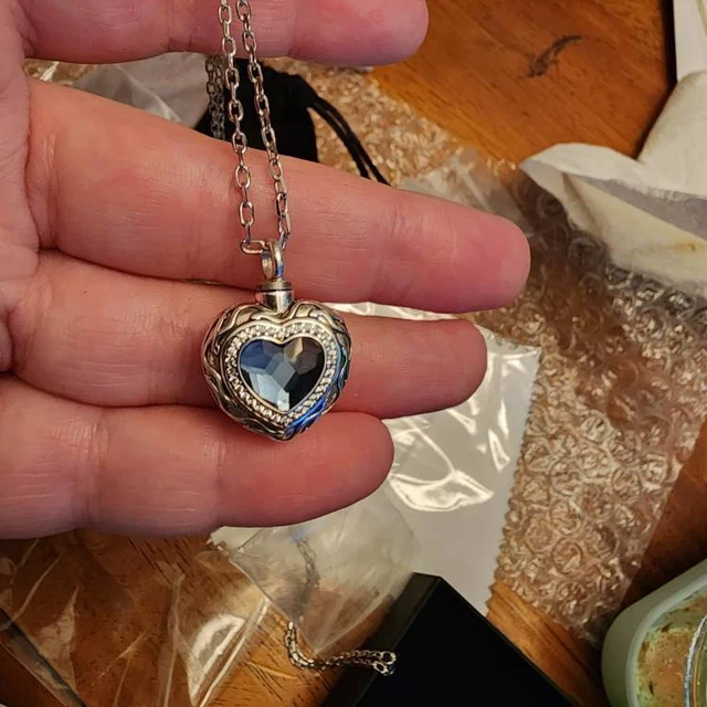 Customer unboxing photo with the Blue Heart cremation necklace and jewelry box